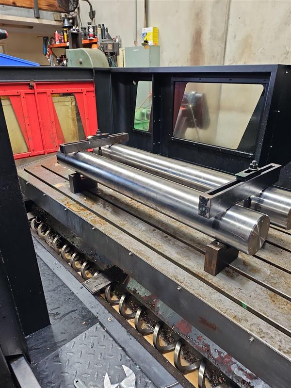 Multiple shafts secured on a machine bed